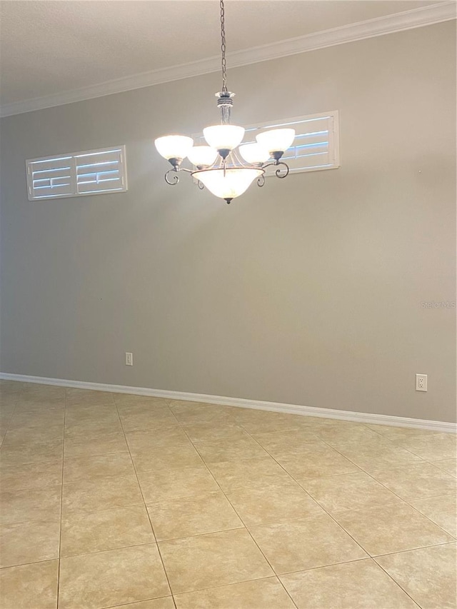 unfurnished room with a chandelier, ornamental molding, and light tile patterned flooring