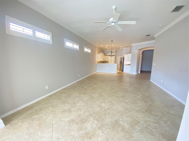 unfurnished living room featuring light tile patterned flooring, a healthy amount of sunlight, ceiling fan with notable chandelier, and ornamental molding