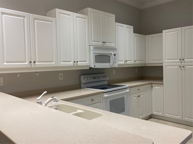 kitchen featuring white cabinets, white appliances, and crown molding