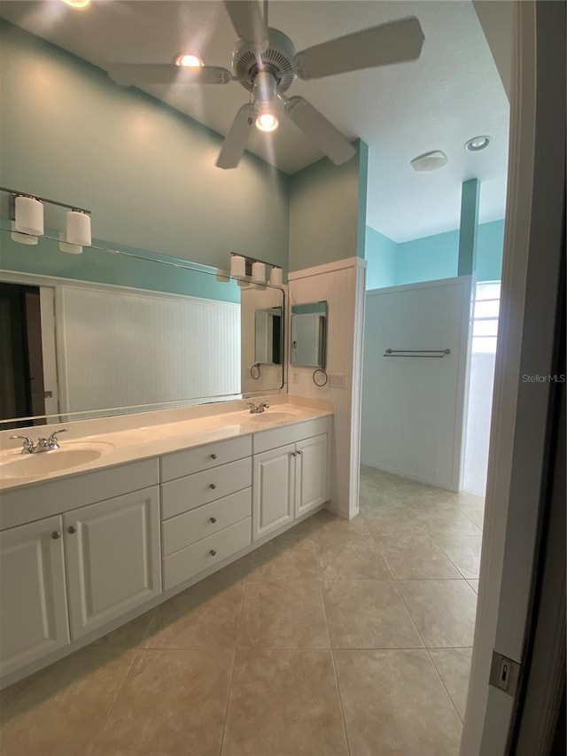 bathroom with ceiling fan, tile patterned flooring, and vanity