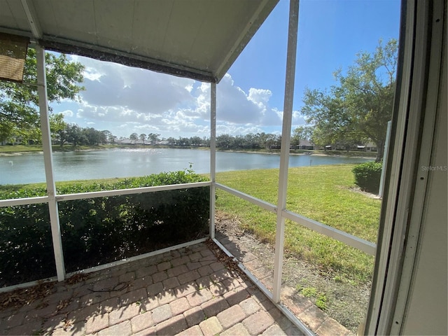 unfurnished sunroom featuring a water view