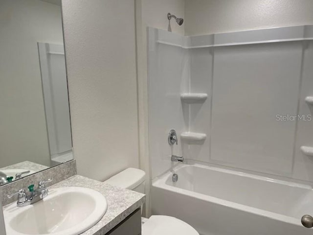 full bathroom with vanity, toilet, and  shower combination