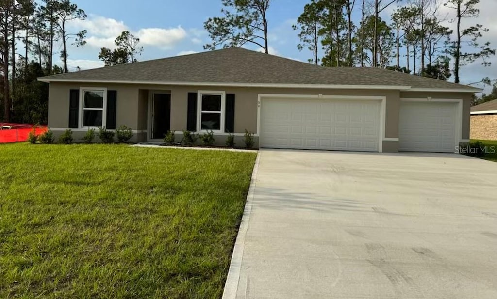 ranch-style home featuring a garage and a front yard