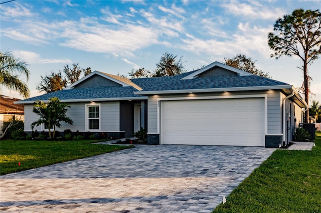 ranch-style house with a garage and a front lawn