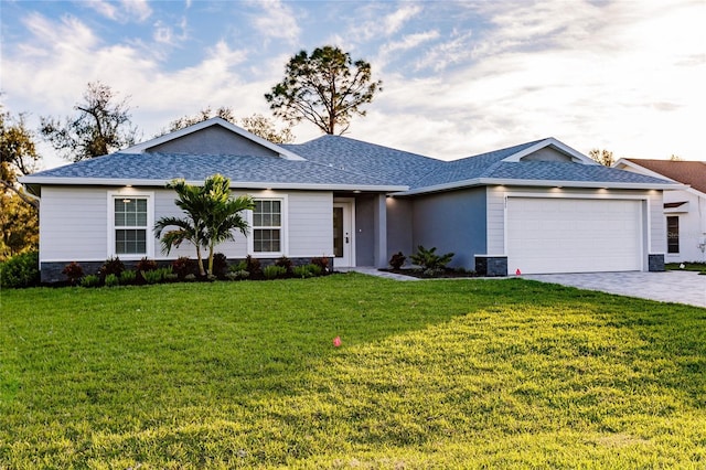 ranch-style home featuring cooling unit, a garage, and a front yard