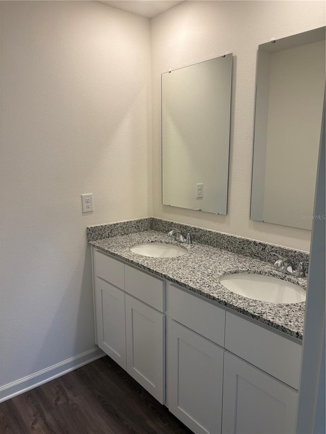 bathroom with vanity and hardwood / wood-style flooring