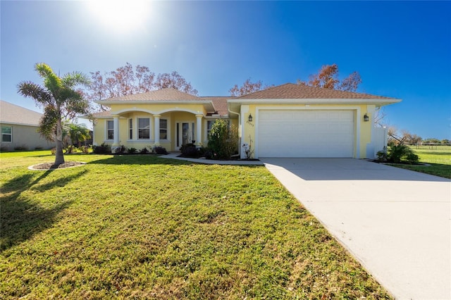 view of front of house featuring a garage and a front lawn