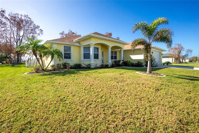 mediterranean / spanish-style home with a garage and a front yard