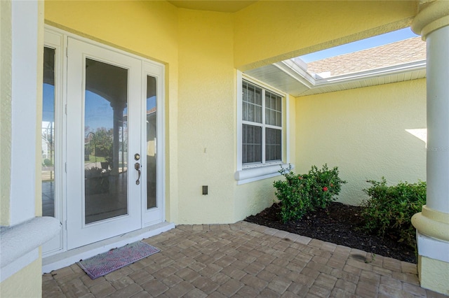 entrance to property featuring a patio and french doors