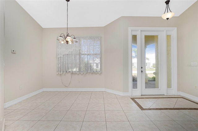 unfurnished dining area featuring light tile patterned floors, lofted ceiling, and a notable chandelier