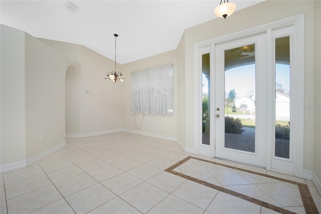 doorway featuring a notable chandelier and light tile patterned floors