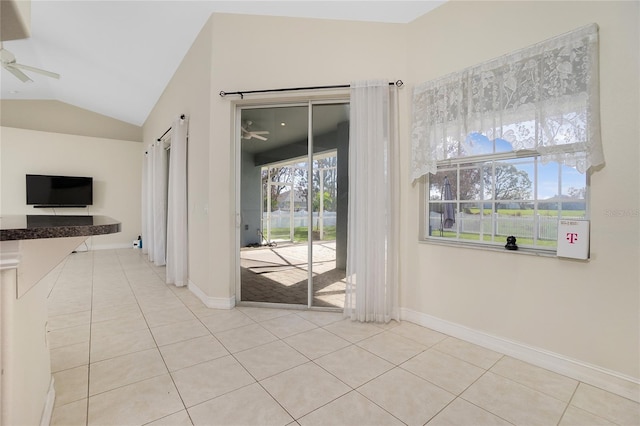 interior space featuring vaulted ceiling, light tile patterned floors, and ceiling fan