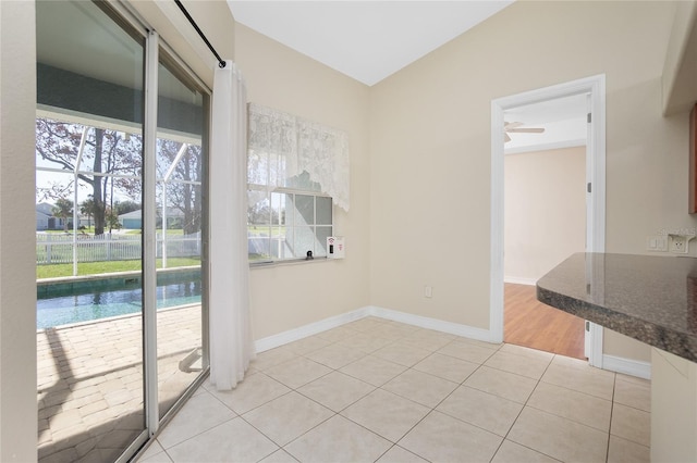 tiled empty room with ceiling fan