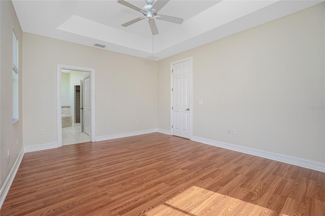 spare room featuring ceiling fan and light hardwood / wood-style floors