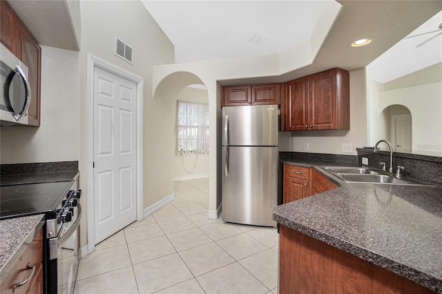 kitchen featuring stainless steel appliances, sink, ceiling fan, and light tile patterned floors