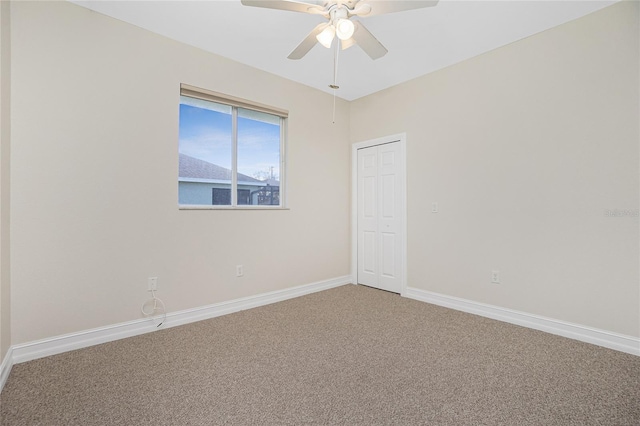 carpeted empty room featuring ceiling fan