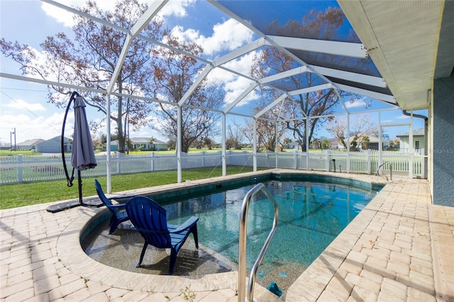 view of swimming pool with glass enclosure and a patio area