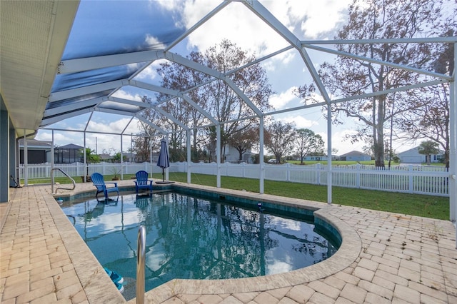 view of swimming pool with a lawn, a lanai, and a patio