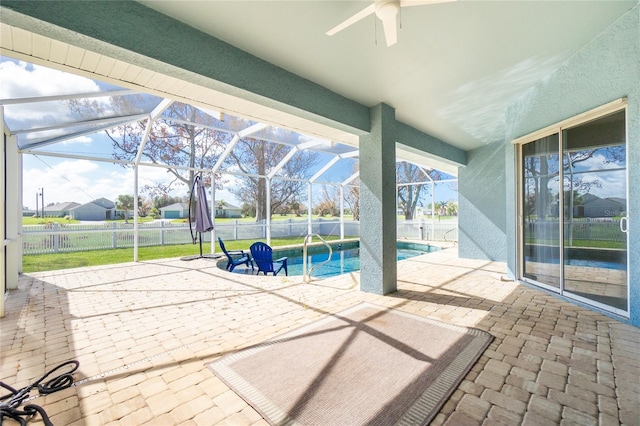 view of patio with ceiling fan, a fenced in pool, and glass enclosure