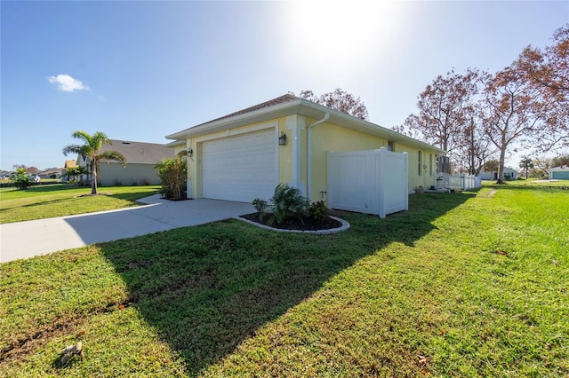 view of side of home featuring a garage and a yard