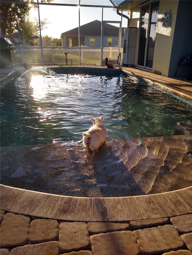 view of pool with a lanai