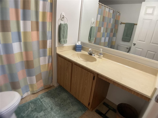 bathroom featuring toilet, vanity, and tile patterned flooring