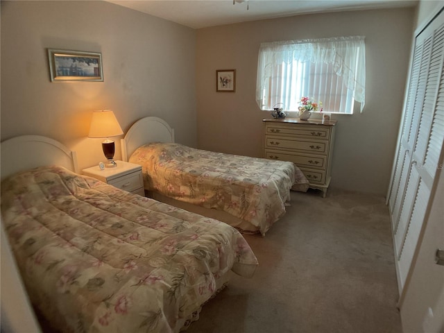 carpeted bedroom with a closet