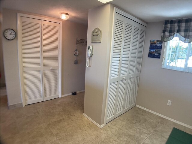 3310 Loveland Blvd Unit 604, Port Charlotte, FL 33980 - hallway featuring light tile patterned floors and baseboards