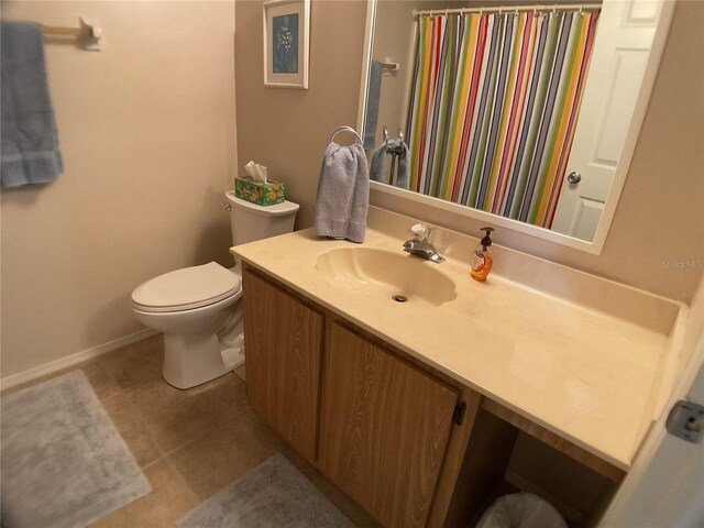 3310 Loveland Blvd Unit 604, Port Charlotte, FL 33980 - bathroom featuring vanity, toilet, tile patterned flooring, baseboards, and a shower with shower curtain