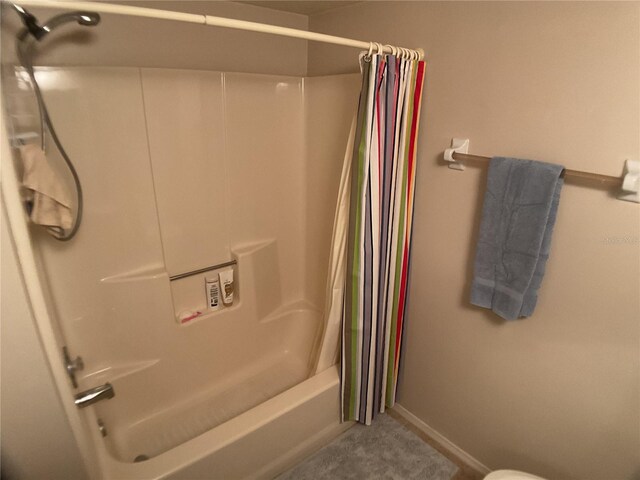 3310 Loveland Blvd Unit 604, Port Charlotte, FL 33980 - bathroom with shower / bath combo with shower curtain, toilet, and baseboards