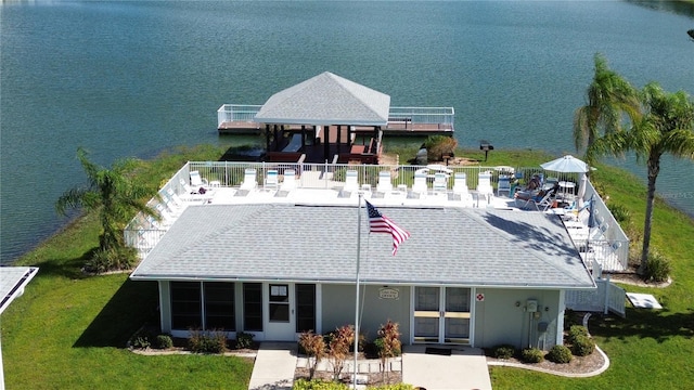 back of property with a water view