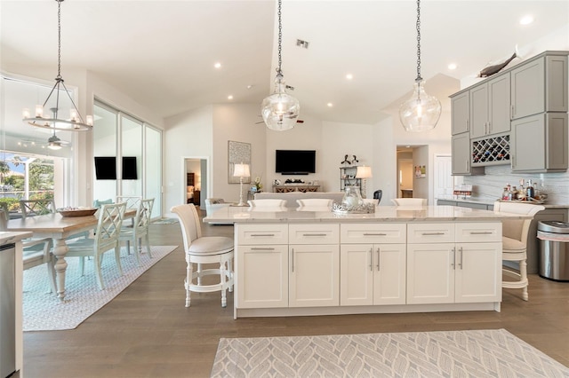 kitchen with tasteful backsplash, a breakfast bar area, and hanging light fixtures