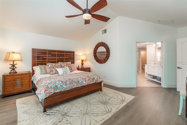 bedroom featuring ensuite bathroom, vaulted ceiling, wood-type flooring, and ceiling fan