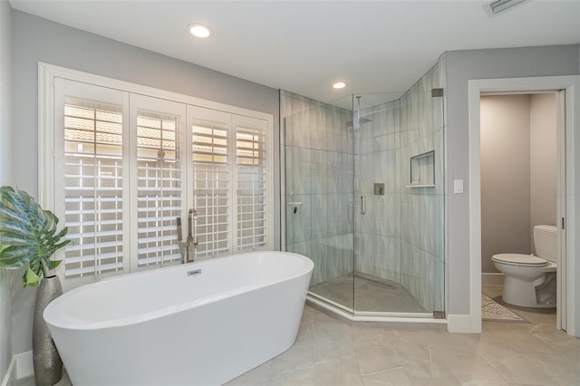 bathroom featuring toilet, tile patterned floors, and independent shower and bath