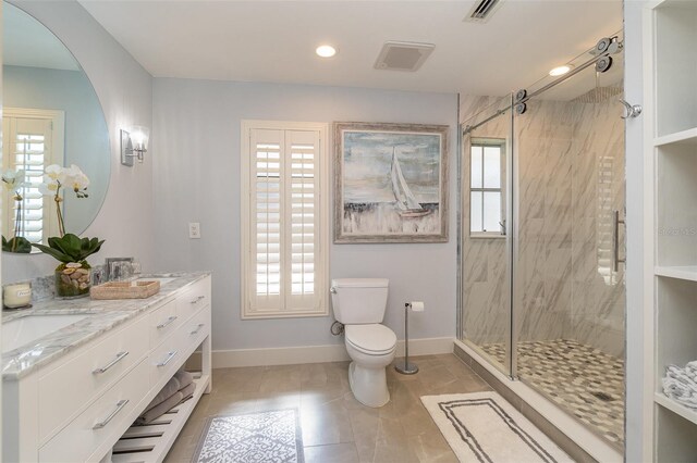 bathroom featuring toilet, an enclosed shower, and a healthy amount of sunlight