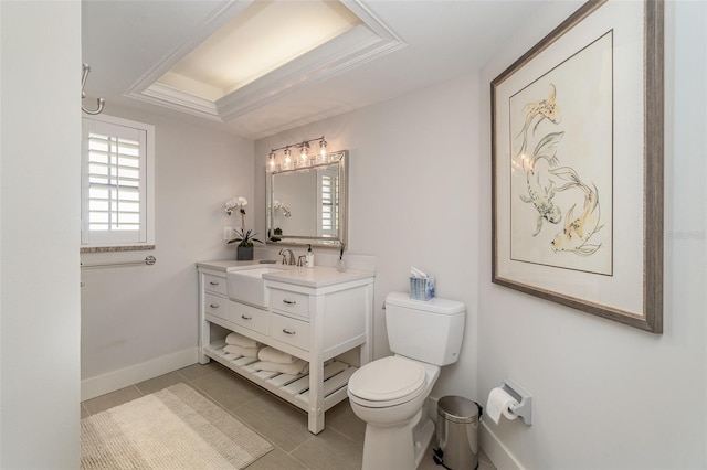 bathroom featuring vanity, toilet, a raised ceiling, and tile patterned flooring