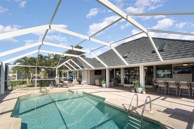 view of swimming pool featuring a patio and glass enclosure