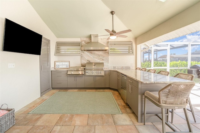 kitchen featuring wall chimney exhaust hood, vaulted ceiling, kitchen peninsula, and gray cabinets