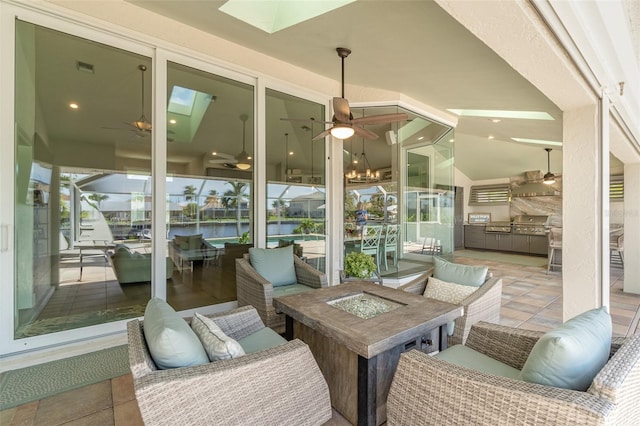 sunroom / solarium with vaulted ceiling with skylight and a water view