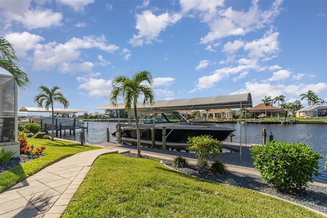 view of dock featuring a lawn and a water view