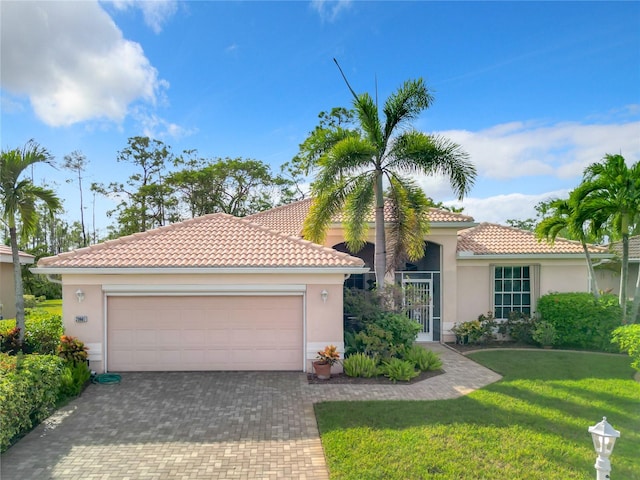 mediterranean / spanish-style home with a front yard and a garage