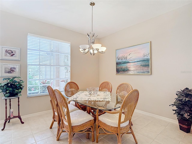 dining space with light tile patterned flooring and a notable chandelier