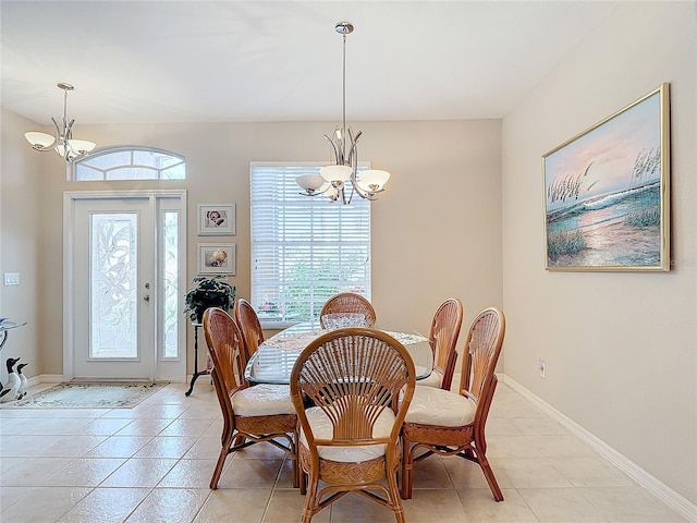 tiled dining space featuring a notable chandelier and plenty of natural light