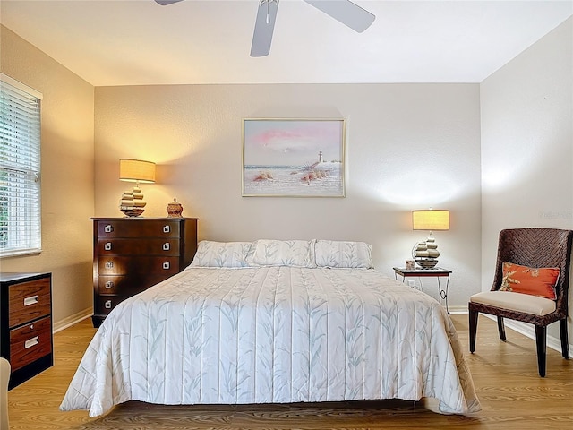 bedroom with hardwood / wood-style floors and ceiling fan