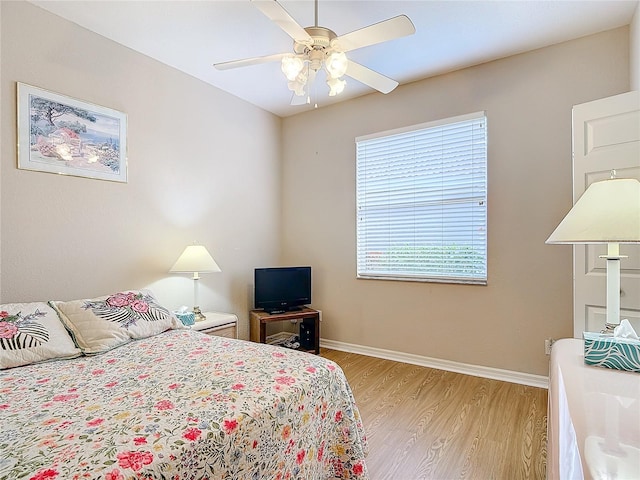 bedroom with ceiling fan and light hardwood / wood-style floors