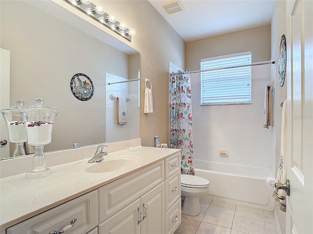 full bathroom featuring vanity, shower / bath combo with shower curtain, toilet, and tile patterned flooring