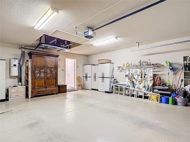 garage with a garage door opener and white refrigerator