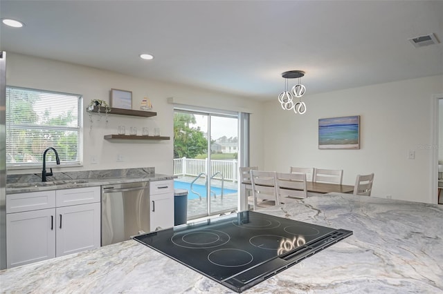 kitchen with dishwasher, sink, light stone countertops, pendant lighting, and white cabinetry