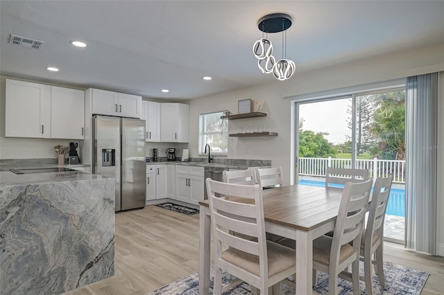 25 Caddy Rd, Rotonda West, FL 33947 - dining space with light wood-style floors and recessed lighting
