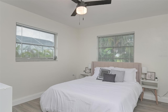 25 Caddy Rd, Rotonda West, FL 33947 - bedroom featuring baseboards, light wood-style flooring, and a ceiling fan